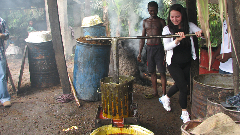 Student Andrea Mlinarevic uses a palm oil press.