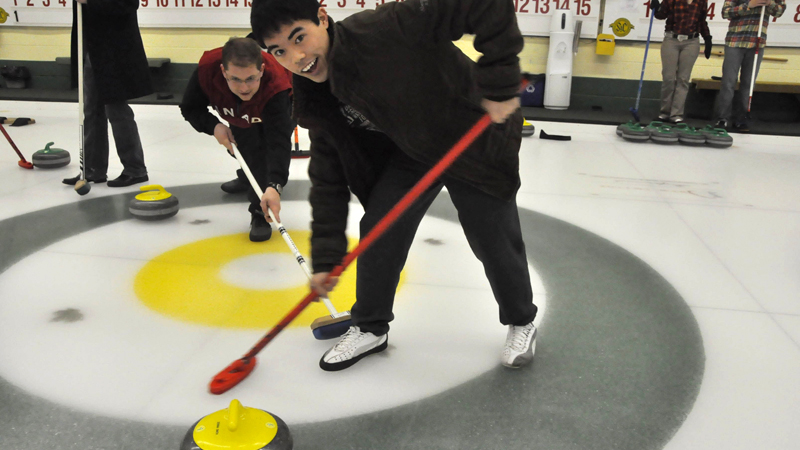 Rob Lanteigne and Kenneth Truong from the Brock University Students' Union curl at the annual alumni curling bonspiel.