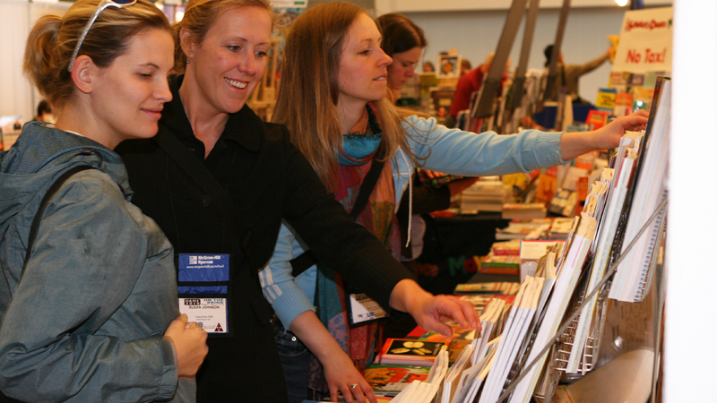 Ashley Meyer, Susan Johnson and Catherine Wiebe from Coronation Public School in the Grand Erie District School Board browse the math books on sale in the Ian Beddis Gymnasium.