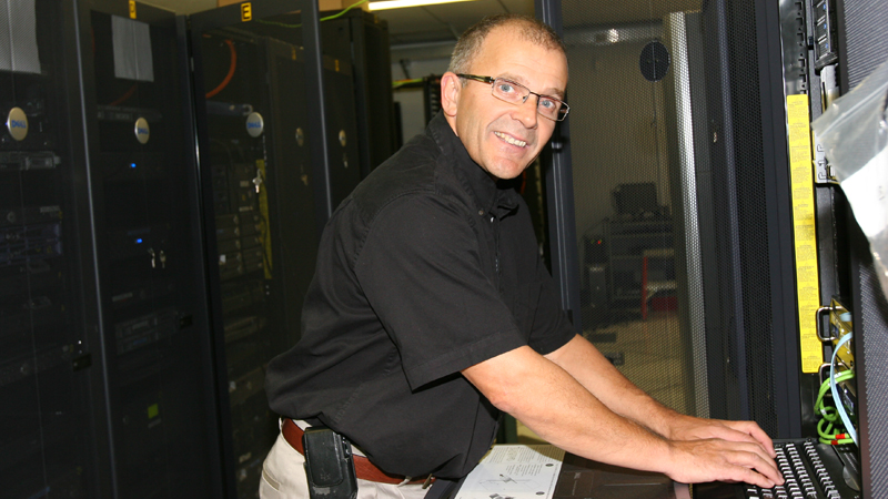 Andy Morgan stands in the server room, a climate-controlled space holds dozens of servers that hold brocku.ca websites, email messages and other data.