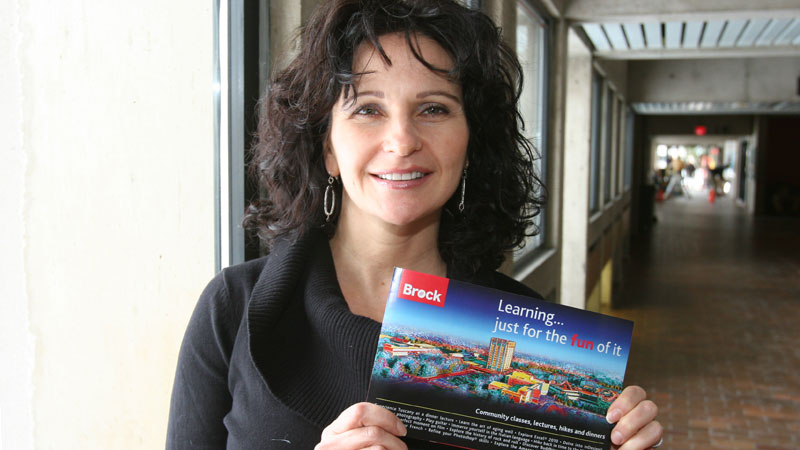 Jacqueline Oscvirk holds the new Continuing Education brochure for winter 2011.