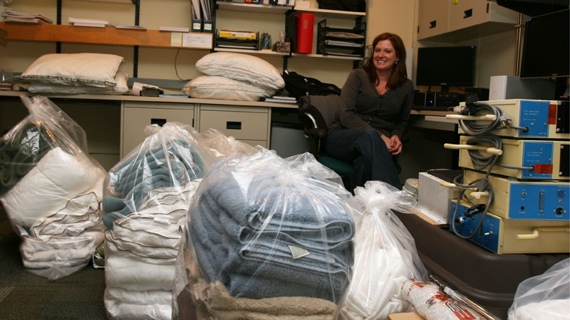 Prof. Kimberly Cote sits in the sleep lab surrounded by towels and blankets that were laundered after an electrical fire this month.