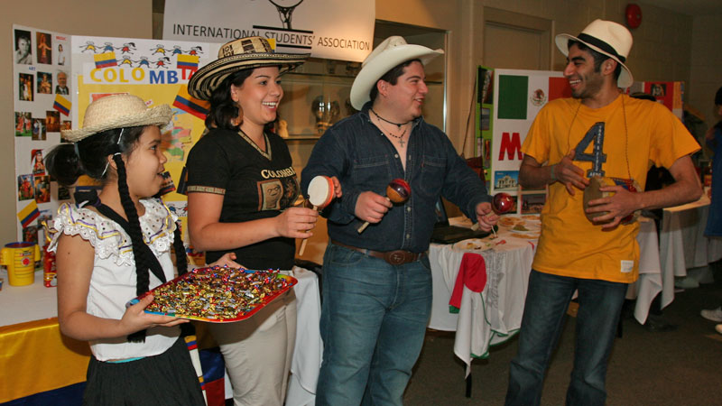 Maria Millan, second from left, celebrates multiculturalism with Rodolfo Tapia (representing Mexico) and Maitham Alawami (representing Saudi Arabia).