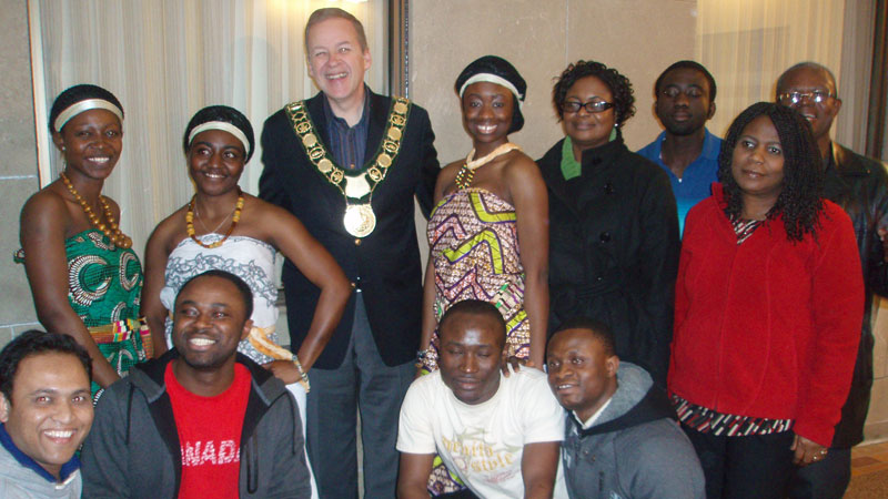 Mayor Brian McMullan poses with graduating international students from Brock.