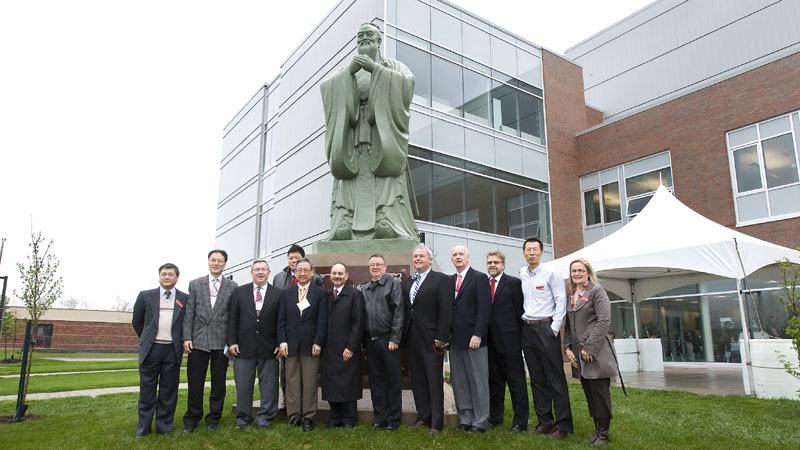 Officials unveil a statue of Confucius.