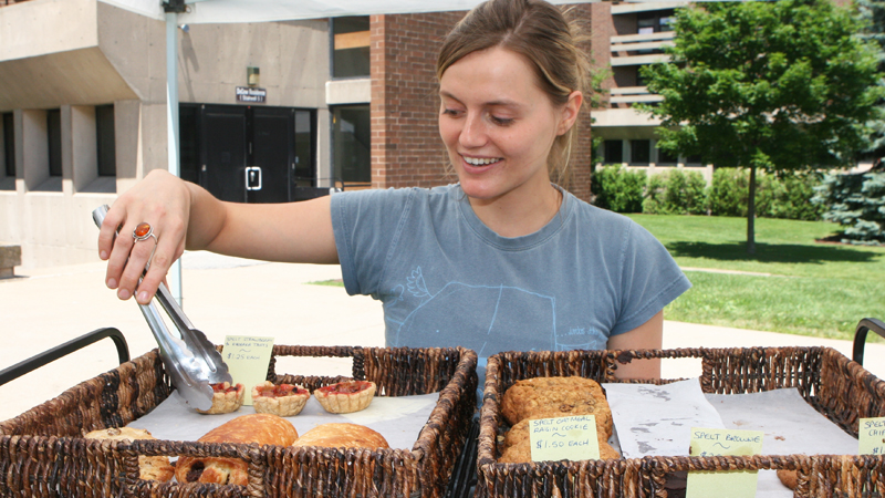 Lauren Holbrook sells fresh bread and pastries from de la terre bakery and café at last year's Farmers' Market.