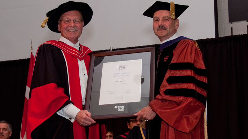 Dan Patterson, president of Niagara College, presents Brock president Jack Lightstone with an honorary degree.
