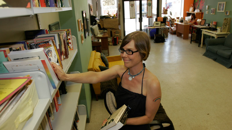 Lisa Kretz shelves books at OPIRG Brock's downtown Infoshop.