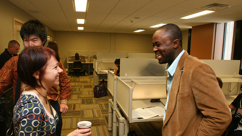Chrissy Lackner, left, and Daniel Antwi-Amoabeng are all smiles at the opening of the Library's new work space for grad students.