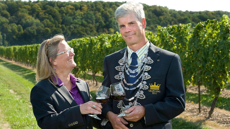 Debbie Inglis hands over the Grape King title to alumnus Ed Hughes.