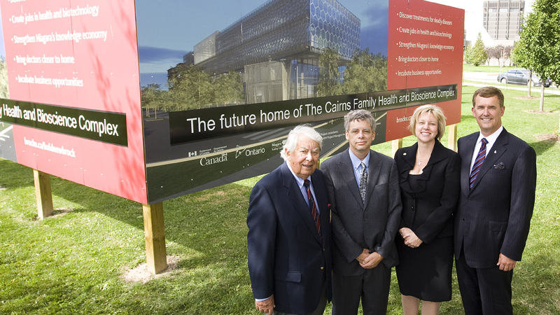 Roy Cairns poses with son John, daughter-in-law Kitty and son Jeff Cairns at the naming of the Cairns Family Health and Bioscience Research Complex.