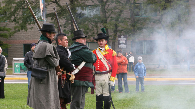 Reenactors stand stoic after musket fire during last year's ceremony commemorating the death of Sir Isaac Brock.
