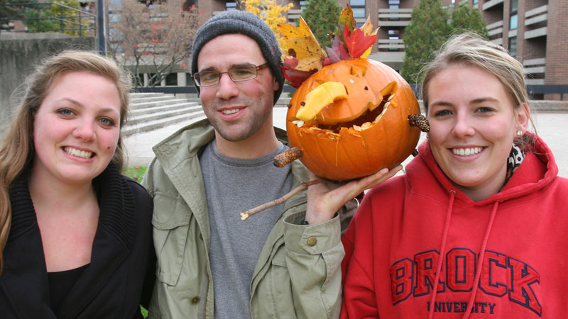 Justine Moller, Jeff Parker and Shelbi Robson, all masters students in Popular Culture, formed at team at the GSA pumpkin carving event.