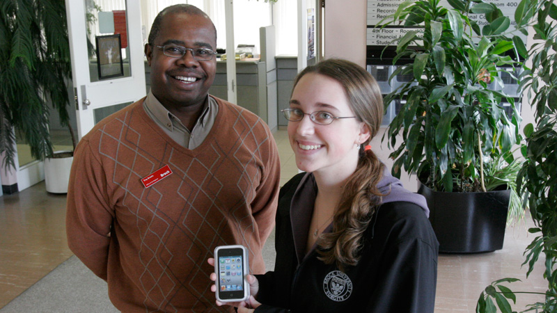 Troy Brooks, academic integrity officer, presents an iPod Touch to Jessica Jones.