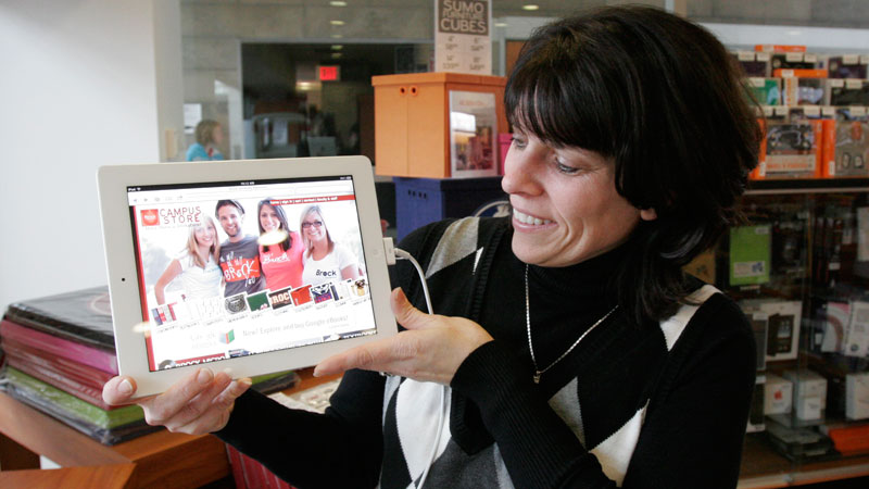 Janet Jamison, assistant director of finance and operations, shows off the Campus Store's new app for digitized books.