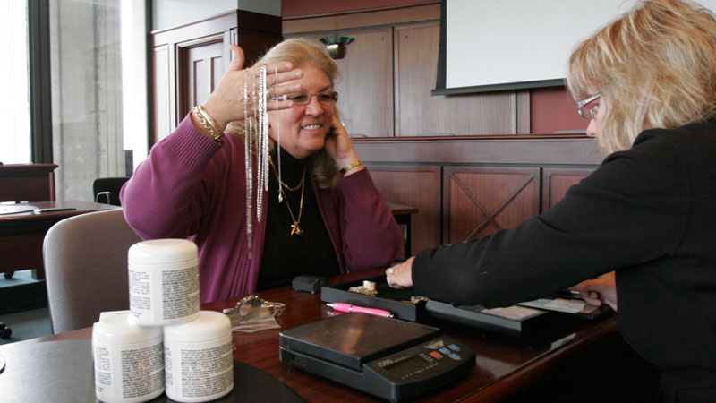 Donna Moody from Campus Security gets gold appraised from the lost and found to donate the proceeds to the United Way.