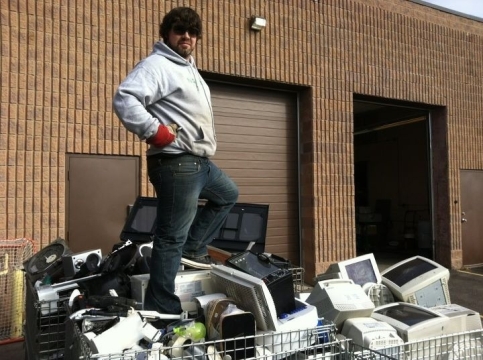 Ryan Dear (BBA ’11), owner of Niagara E-Waste, posed with recycled electronics after a successful event
