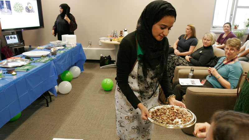 Student Azof Aiash serves date appetizers during a Saudi cooking demonstration at the International Centre on Wednesday. The demonstration was part of International Education Week.