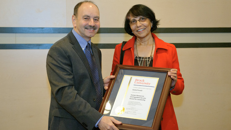 Geeta Powell receives the Human Resources Distinguished Service Award for Leadership from President Jack Lightstone at the President's Holiday Celebration on Dec. 6.