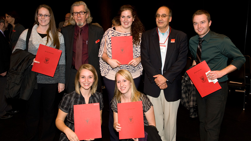 Interim Dean Rick Cheel and Hichem Ben-El-Mechaiekh, Associate Dean Undergraduate Studies, posed with a number of students at the recent Mathematics and Science Awards Assembly.