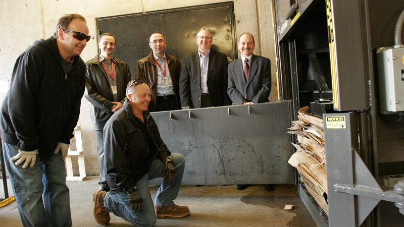 Checking out the new cardboard baler are (in front) Russ Higham and Ken Wake from Custodial Services, (back row, left to right) Domenic Maniccia, director of Custodial Services; Tom Saint-Ivany, Associate Vice-President of Facilities Management; Steven Pillar, Vice-President Finance and President Jack Lightstone.