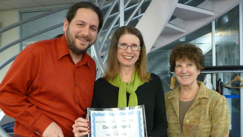 Nancy Gill, center, received the award from Pablo Felices Luna, artistic director of the Carousel Players, and Debra McLauchlan, chair of the board.