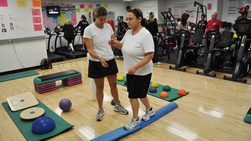 Kim Gammage, left, works with Helene Breton train at a Brock gym.