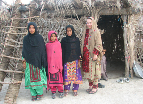 Associate professor of history Behnaz Mirzai (right) with three Baluchi girls in Baluchistan.