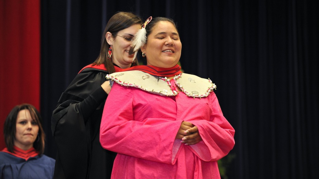 Ojisda Aimy Anderson enjoys the moment as she is hooded by Renee Bedard during convocation on Oct. 13.
