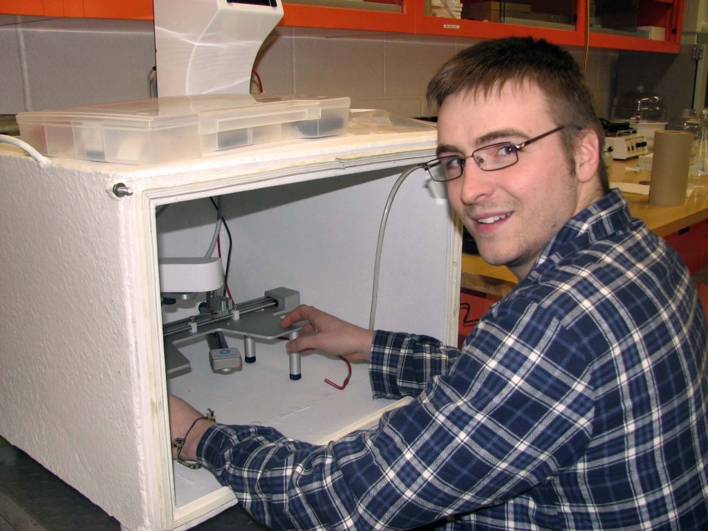 PhD student Drew Marquardt shows the Langmuir Trough enclosure that he and his father recently constructed for Marquardt’s use in his oral hygiene research.