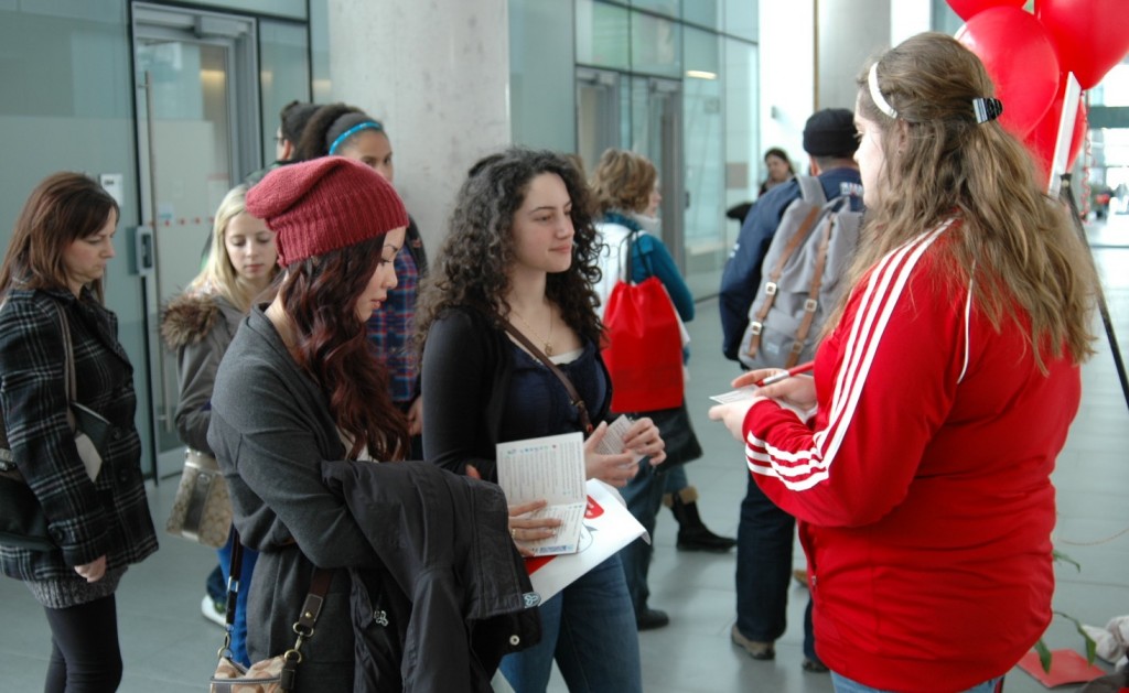 Prospective students Helen Le (red cap) and Nour Alideeb, attending from Mississauga, chat with guide Victoria Maxmen on Sunday.