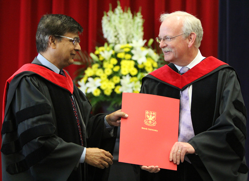 Ejaz Ahmed, Dean of Mathematics and Science, presents Prof. Alan Castle with the Faculty Award for Excellence in Teaching Friday morning. 