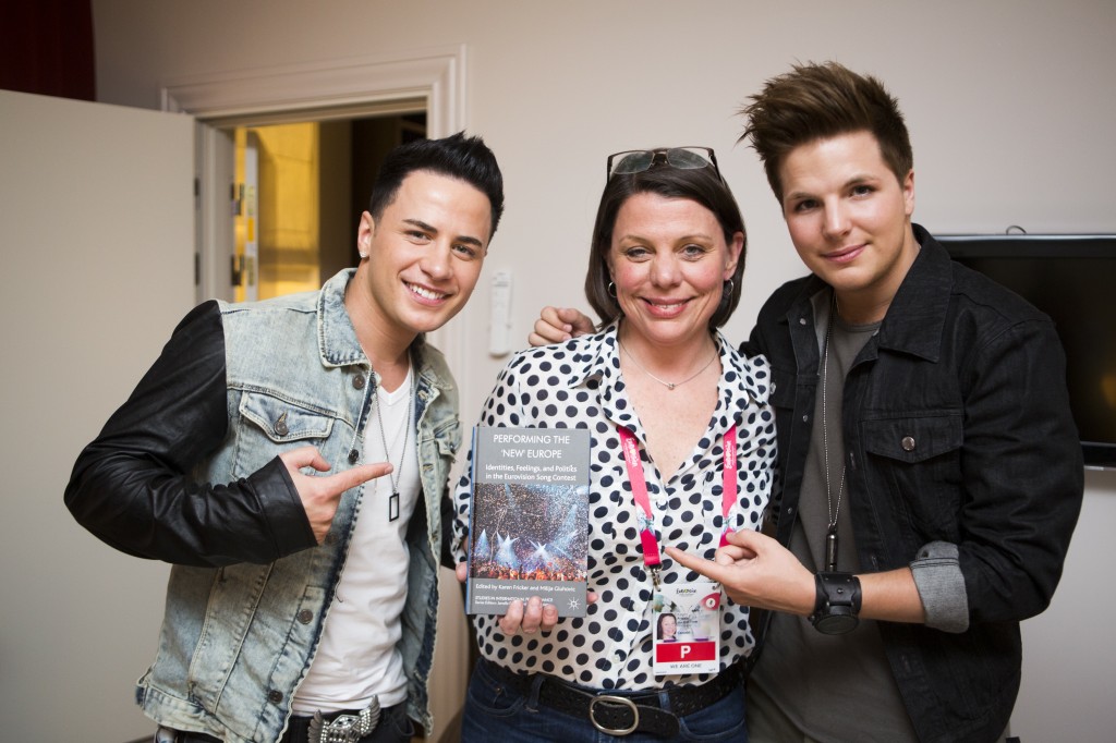 Eurovision performers Ryan Dolan of Ireland (left) and Robin Stjernberg of Sweden give Prof. Karen Fricker and her new book about the Eurovision Song Contest the OK. Photo by Lisa Wikstrand.