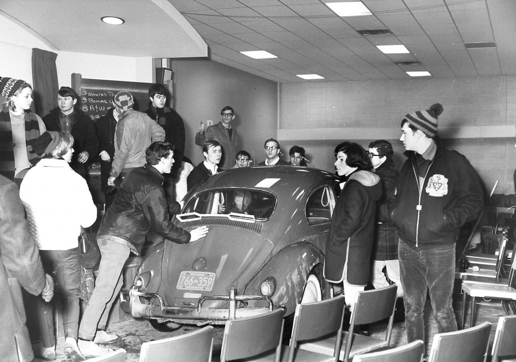 To create a stir during the third Winter Carnival festivities, students push a Volkswagen through the corridors of the campus and parked it in front of the auditorium stage, where it sat until the end of the day.   