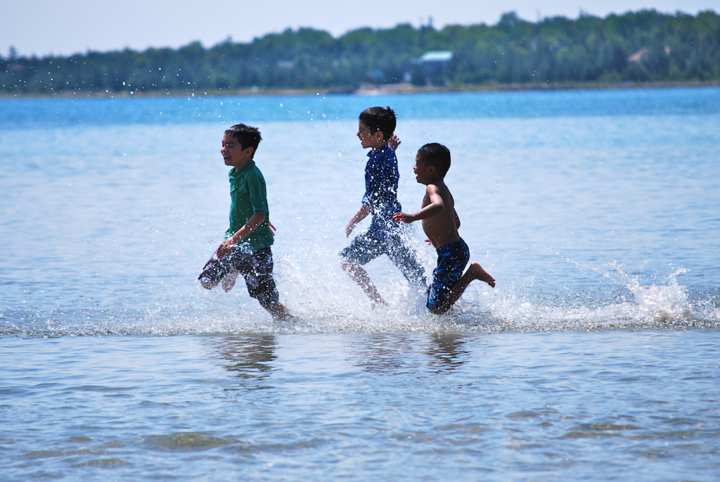 David Sharron's winning photo of his sons Nick and Alex, and their cousin Owen running through the water at Singing Sands Beach.