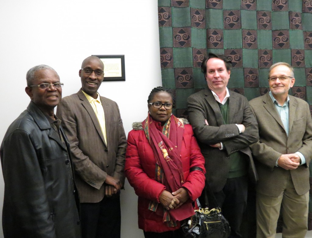 Daniel Frye (from left), Prof. Jean Ntakirutimana, Felicia Frye, Prof. Pierre Lizee, Politcial Sciences chair, and John Kaether, director of Internationl Services, show off the new tapestry in the Political Sciences meeting room that was donated by retired professor Dennis Essar.