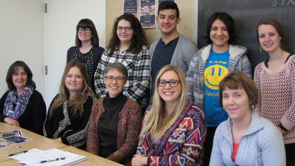 Prof. Mary-Beth Raddon, seated second from left, with SJES graduate students involved in organizing the annual Niagara Social Justice Forum. Seated from left: Liz Mooney, Lisa Trumble-Pauze, Raddon, Blaire Hinsperger-Fox, Cheryl Thompson Standing from left: Lauren Quinn, Kate Paterson, Daniel Gallant, Ezgi Sarioglu, Kate MacDonald. Absent was Sarah Mann.