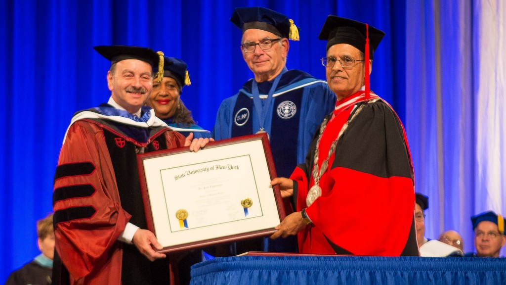 Brock President Jack Lightstone (left) is presented with an Honoray Doctorate from the University at Buffalo on May 18.