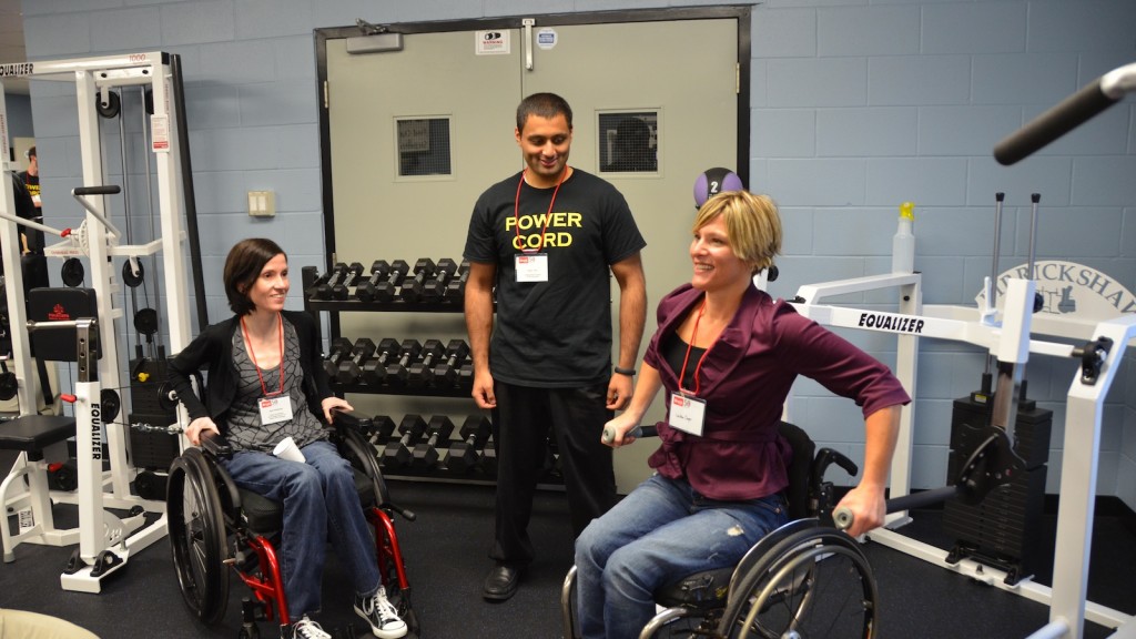 LeaAnn Cayer (right) demonstrates how the Power Cord facilities accommodate a full range of exercises for individuals with spinal cord injury.