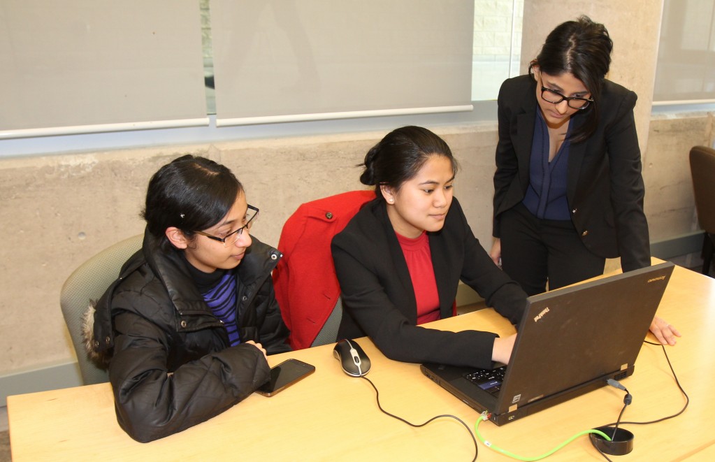 Student Feby Jose, left, gets tax preparation help from Accounting Co-Op students Alyssa Gambel and Shreya Verma Monday afternoon. 