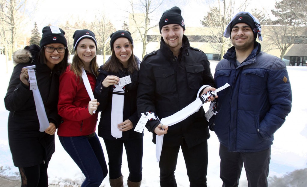 Students Cate Talaue, Kelsey Kavanagh, Carly Dugo, Spencer Dawson and Navid Shahabadi show off their Raise the Roof tuques and socks, available for purchase with a pancake breakfast March 11 in support of homelessness organization Raising the Roof.