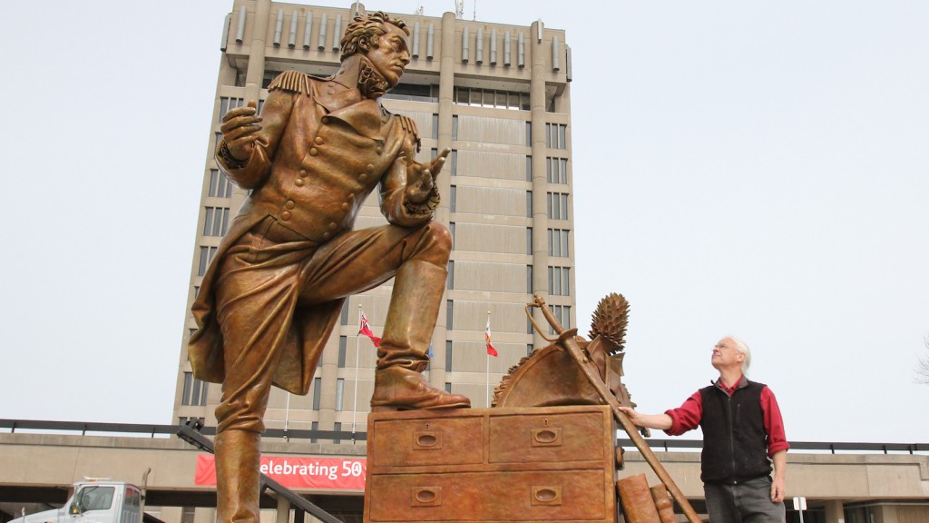 Artist Dane Mozdaenski takes in his sculpture of Maj.-Gen. Sir Isaac Brock after it was erected in front of the Schmon Tower Monday. 