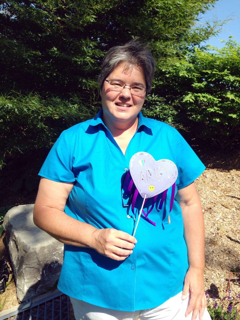 Sherri Vansickle holds a heart with her grandmother Ariel's name. It was one of 900 hearts staked in campus gardens last week to honour those lost to Canada's Indian Residential School System. 