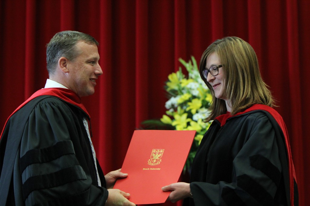 James Mandigo, Interim Health Science Dean, presents Madelyn Law, associate professor, with the Faculty Award for Excellence in Teaching Friday.