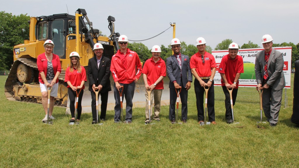 Brock University officials turn the sod to kick off construction of a new artificial turf field.