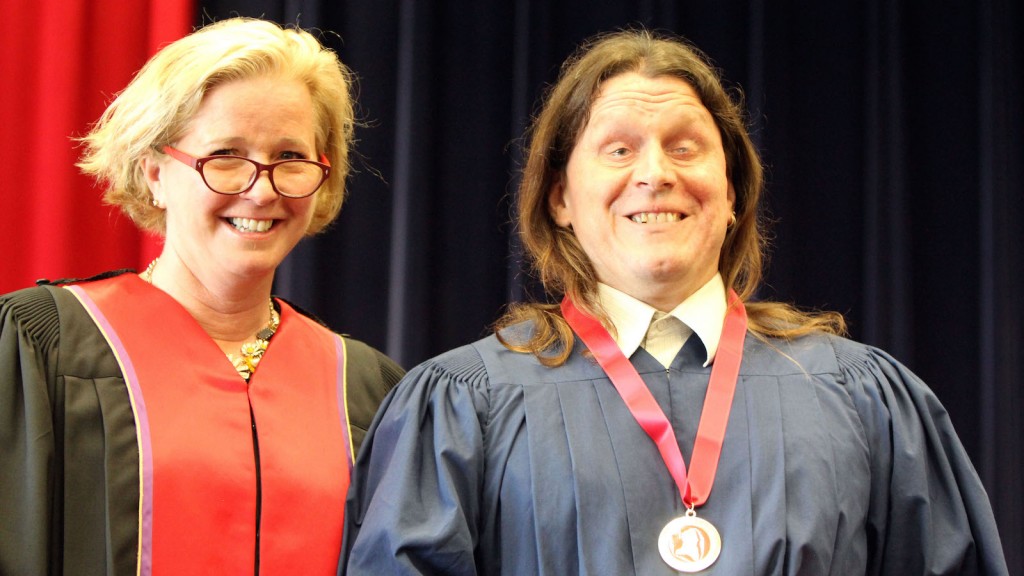 William Morgan received the Spirit of Brock medal from Carolyn Hurst of Brock's Board of Trustees at Wednesday morning's Faculty of Education convocation ceremony. 
