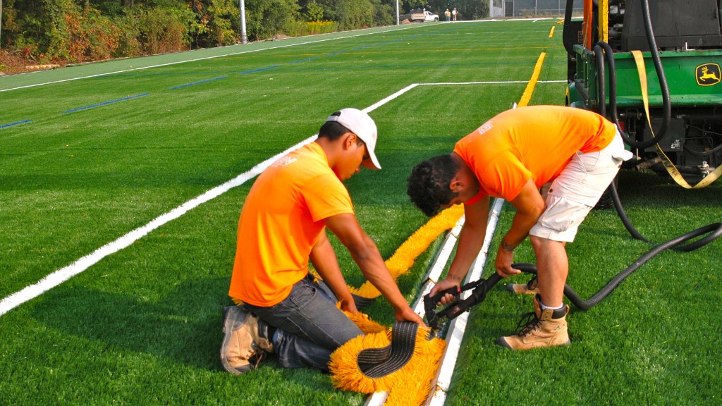 Workers this week are glueing in coloured line markers for different sports that will use the new turf field. 