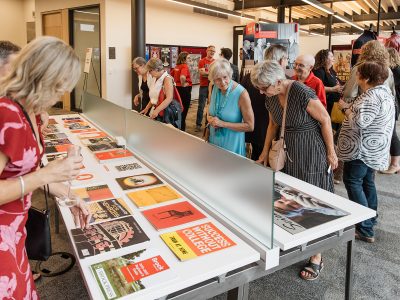 People gather around to look at displays of artifacts and historical materials at Brock University's Skyline Celebration.
