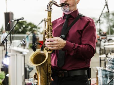 A man plays a saxophone.