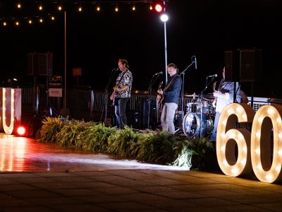 A band plays music at an outdoor evening party.